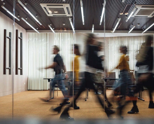 View of various people walking in an office building