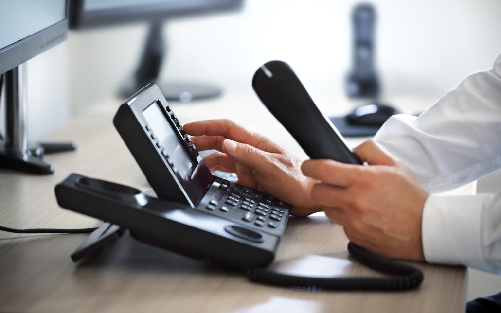 Image of a person using a VoIP phone.