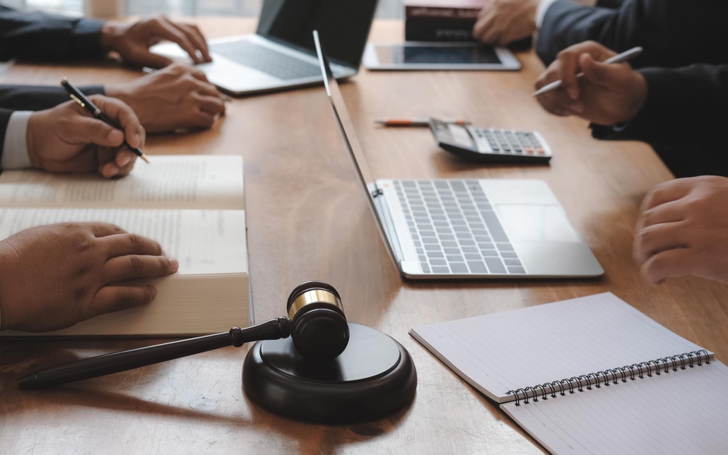 Image of lawyers sitting at a table with laptops. Image of lawyers sitting at a table with laptops.