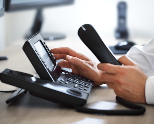 Image of a person using a VoIP phone.