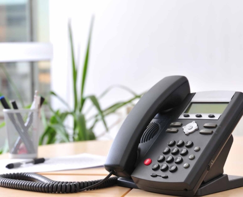 VOIP solutions phone sitting on a desk