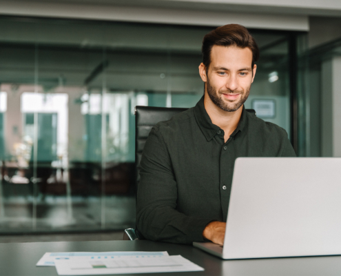 Young professional it specialist European business man working on laptop